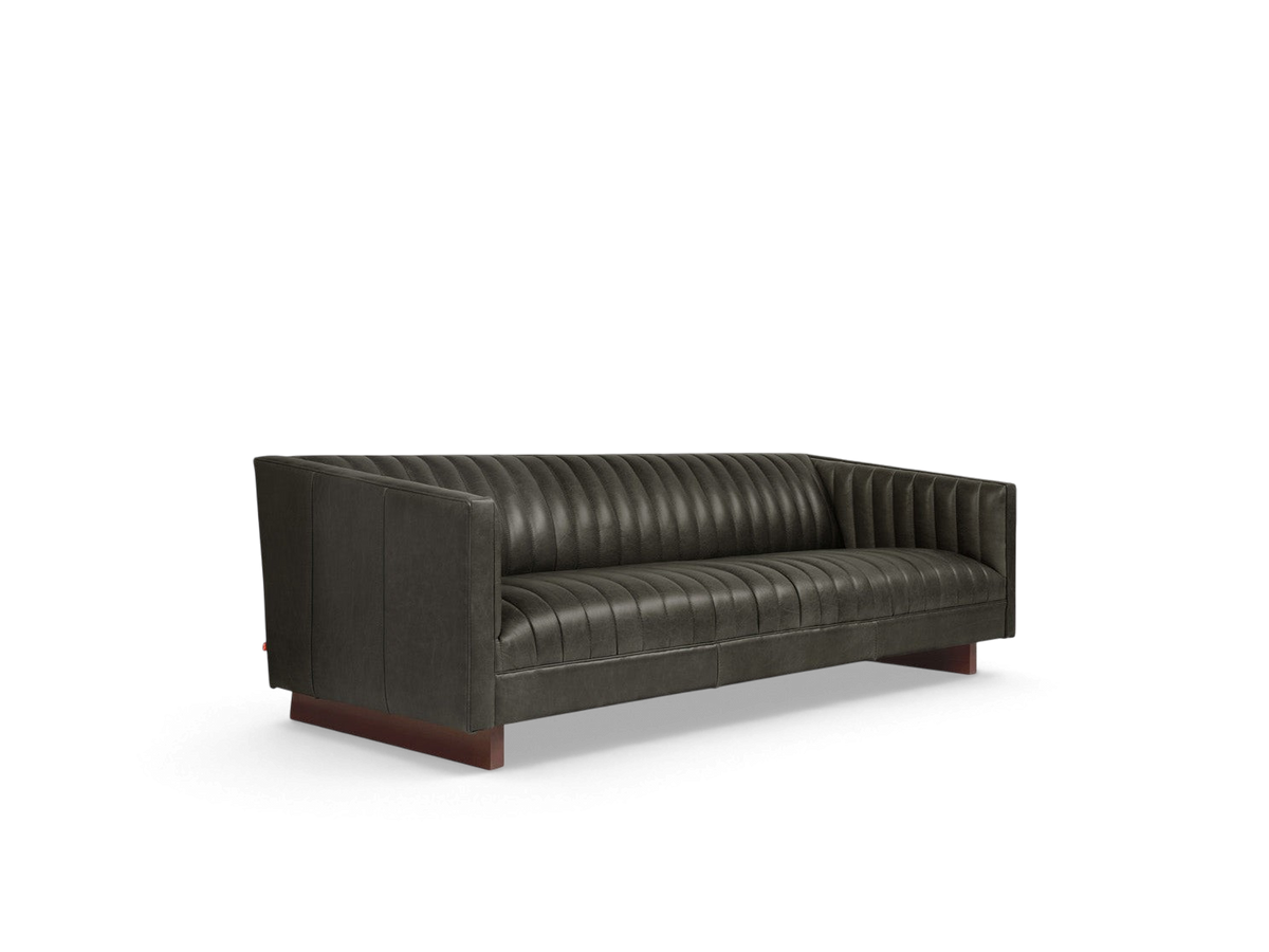 urbane EQ3 Wallace Sofa in dark leather with channel-stitched upholstery and walnut-stained wooden base