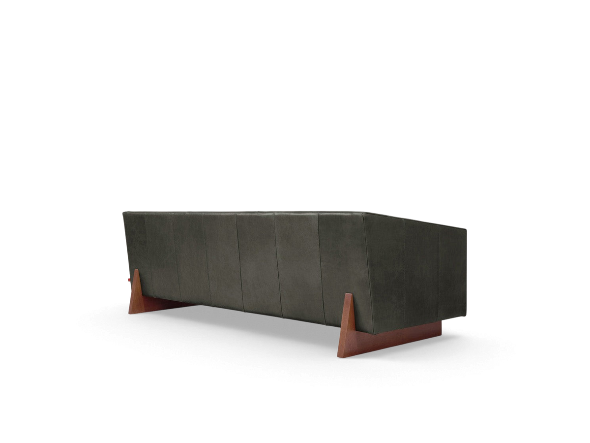 urbane EQ3 Wallace Sofa featuring channel-stitched dark leather upholstery and a sculptural walnut-stained wood base.