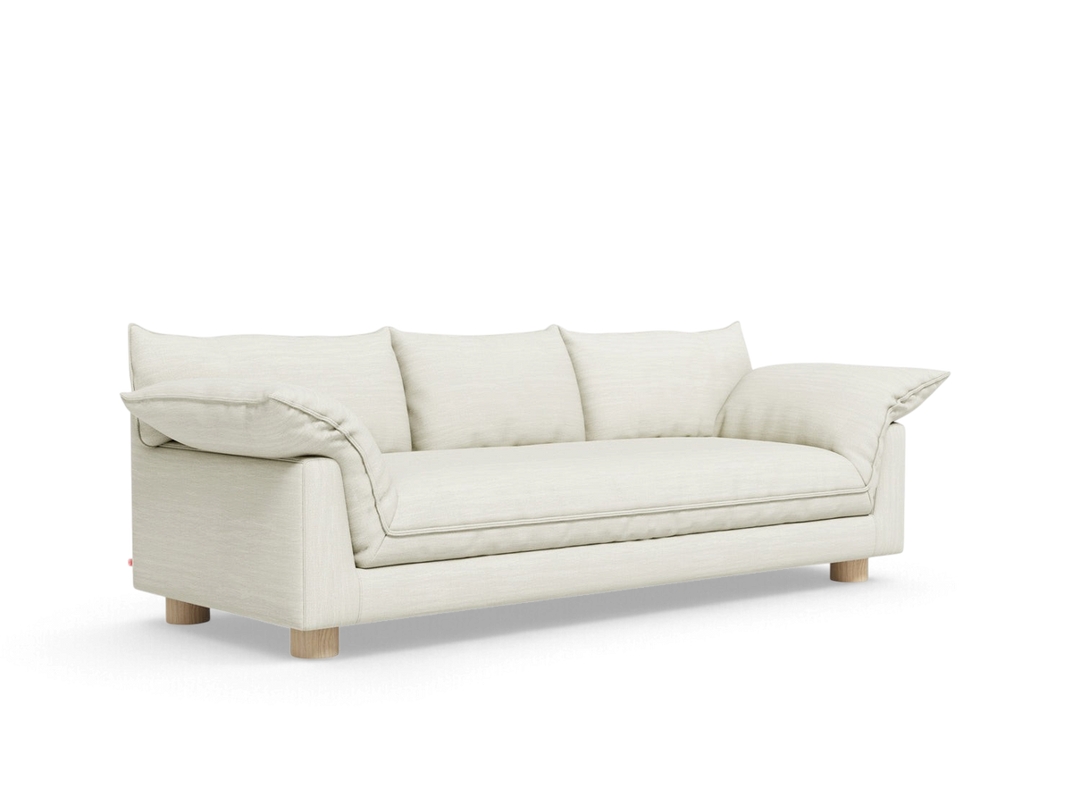 urbane EQ3 Zoe Sofa in cream fabric with French seam detailing and light oak legs on a white background