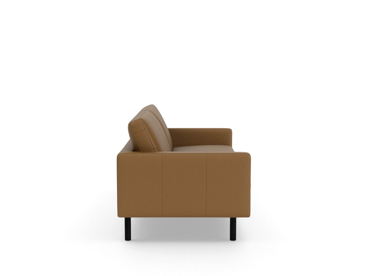 Side view of the urbane EQ3 Joan 83 inch mid-century modern sofa in tan upholstery with black legs