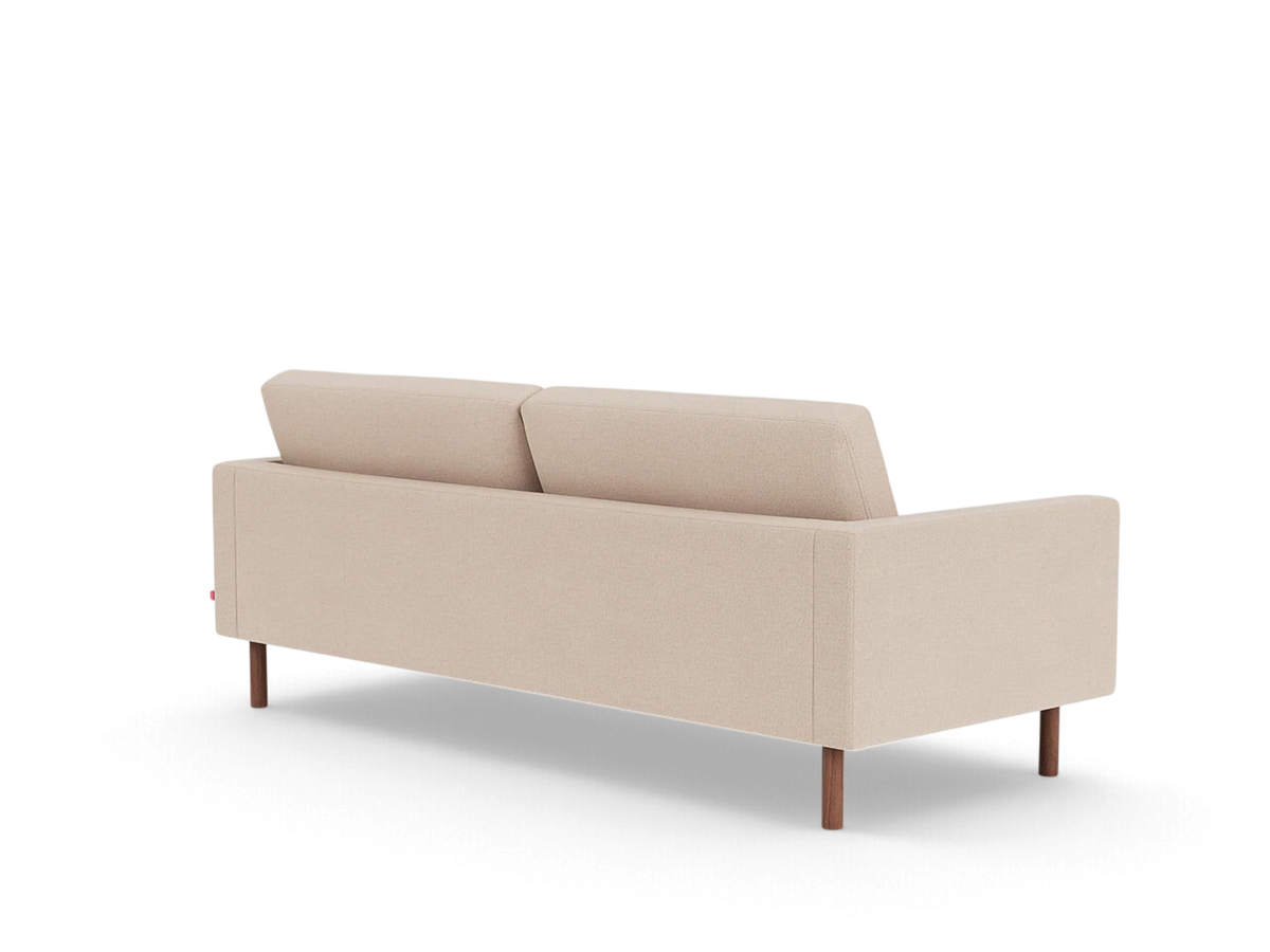 Back view of the beige upholstered urbane EQ3 Joan 83 inch tufted sofa with mid-century wooden legs