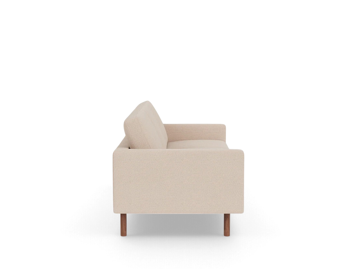 Side view of the urbane EQ3 Joan 87 inch mid-century modern sofa in beige fabric with wooden legs