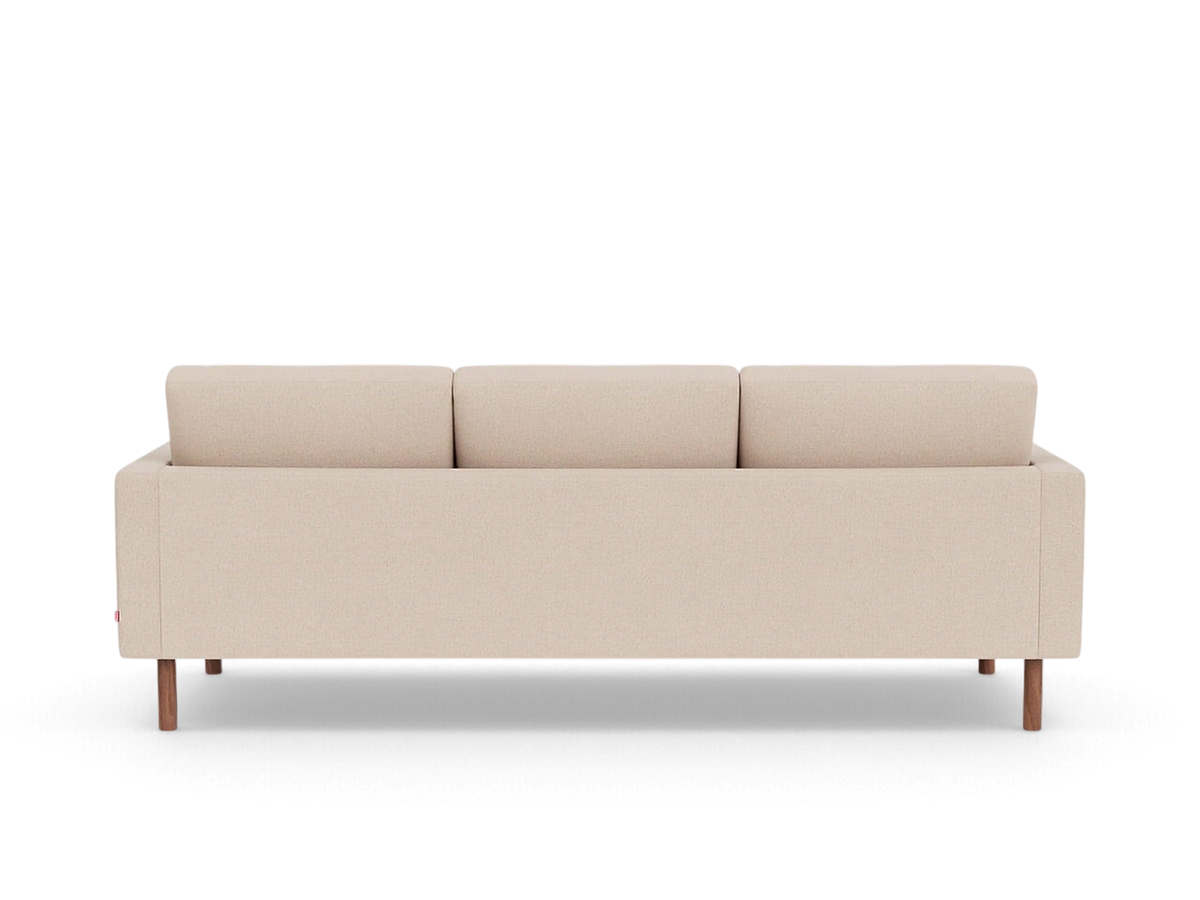 Back view of the urbane EQ3 Joan 87 inch sofa in a neutral beige fabric with tapered wooden legs.