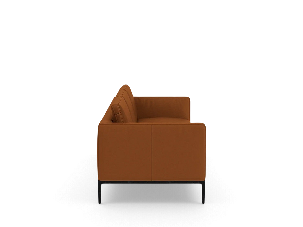 Side profile of the urbane EQ3 Oma 101 inch sofa in a rich brown upholstery with a sleek black anthracite metal base.