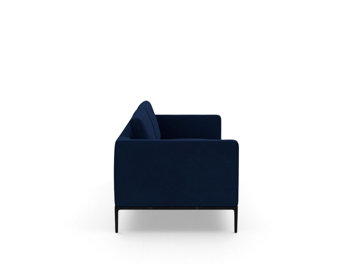 Side view of the urbane EQ3 Oma 89 inch sofa in deep blue upholstery with a sleek black anthracite metal base.