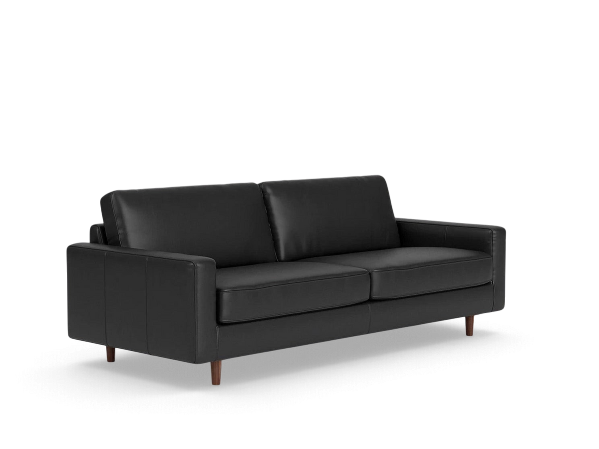 urbane EQ3 Oskar 85-inch black leather sofa with a classic design, loose cushions, and tapered wooden legs