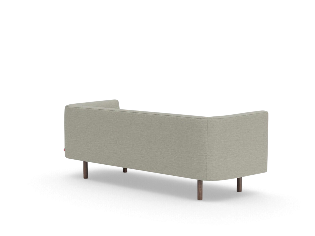 Back view of the urbane EQ3 Replay Club sofa in a neutral beige fabric with dark wooden legs.