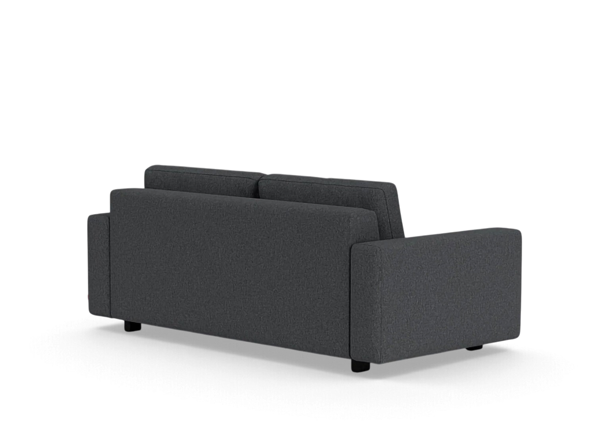 Rear view of the urbane EQ3 Reva double sleeper sofa in dark grey fabric with a modern, compact silhouette.