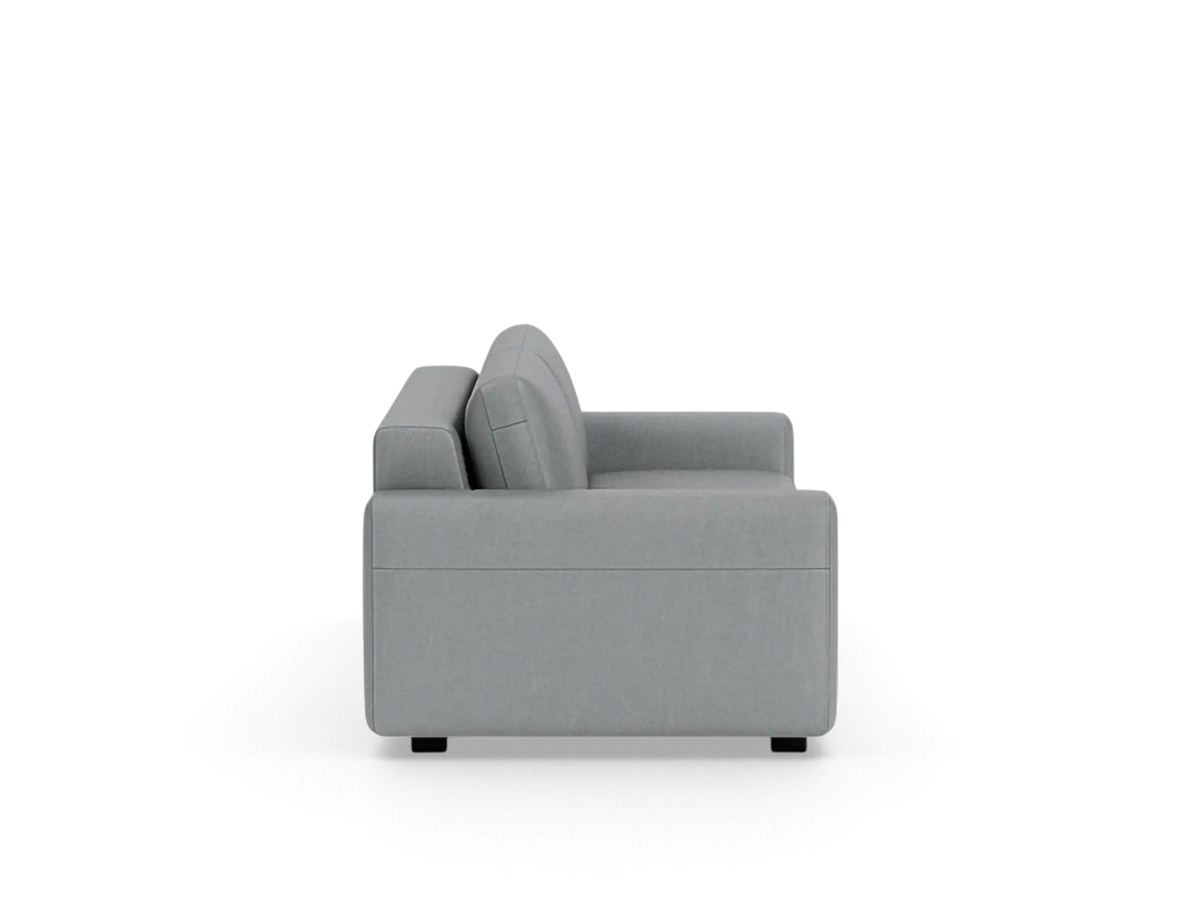 Side view of the grey upholstered urbane EQ3 Reva double sleeper sofa with a sleek modern silhouette.