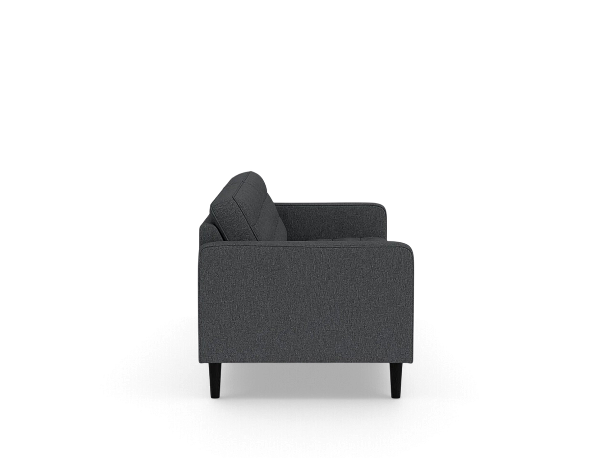 urbane EQ3 Reverie 86-inch sofa in dark grey fabric with button-tufted cushions and tapered wooden legs, side view