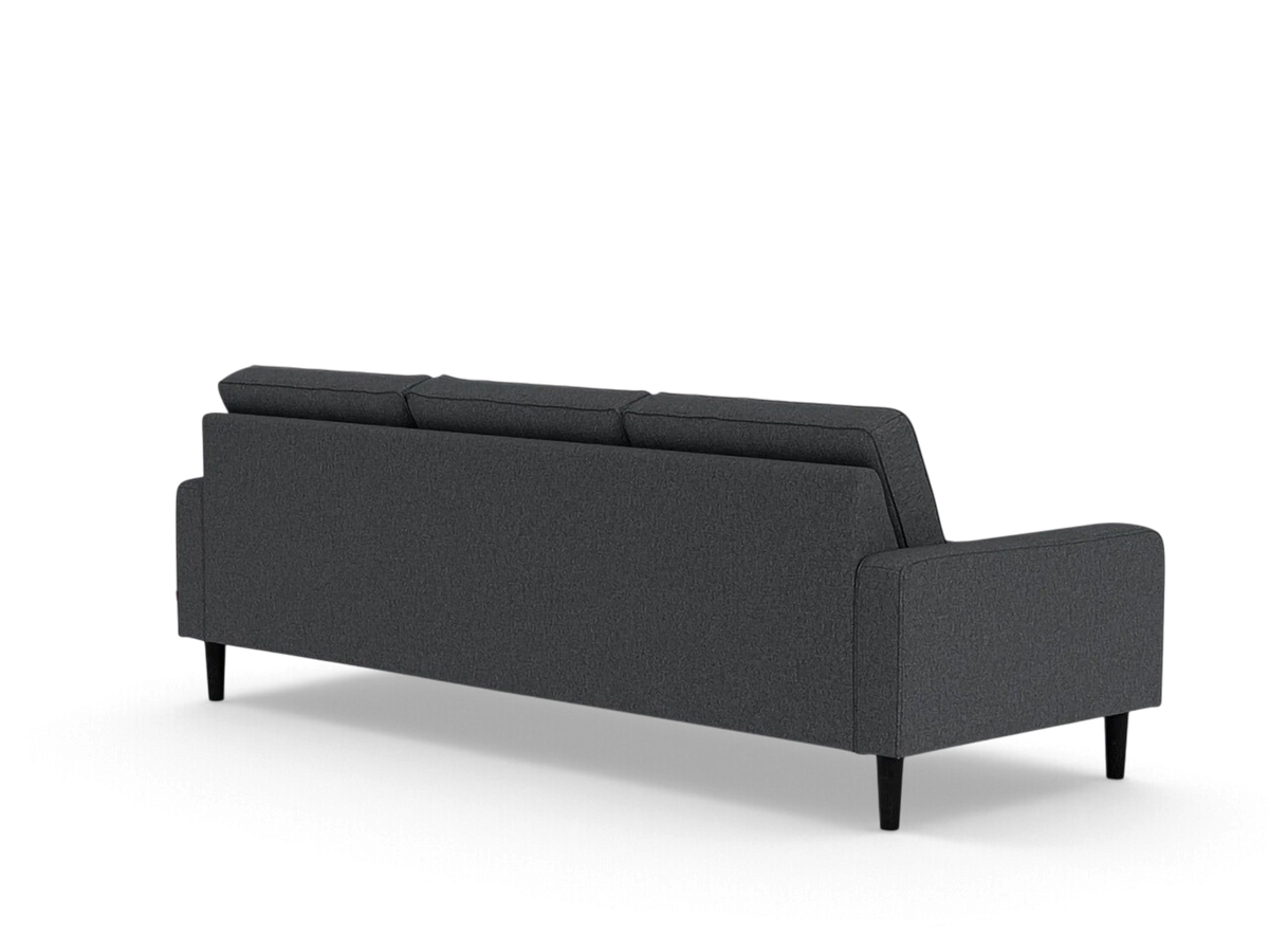 urbane EQ3 Reverie 92-inch sofa in dark grey fabric with tapered wooden legs, shown from a rear three-quarter view.