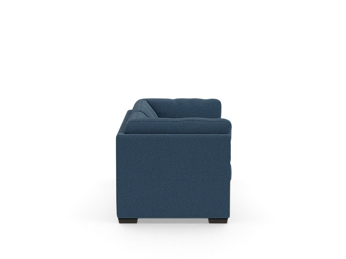 Side view of the blue upholstered Salema sleeper sofa from urbane EQ3 with a modern, low-profile design.