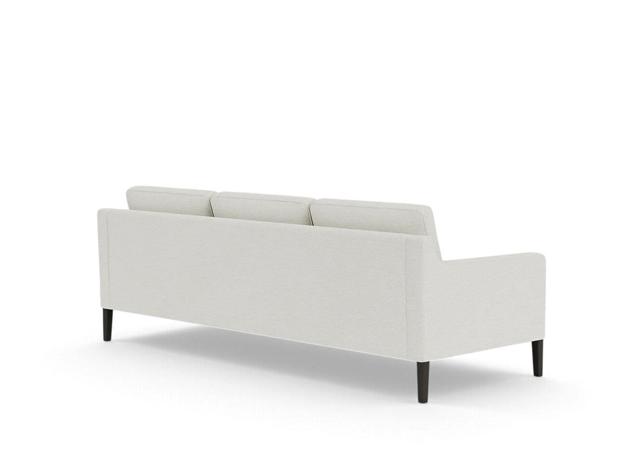 urbane EQ3 Skye sofa in light grey fabric with tapered dark wood legs, viewed from the back in a minimalist style.