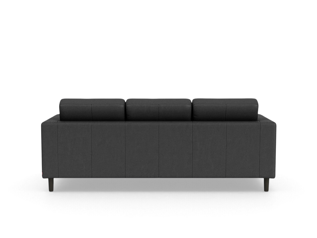 Back view of the urbane EQ3 Solo sofa in charcoal grey fabric with simple architectural lines and dark wooden legs.